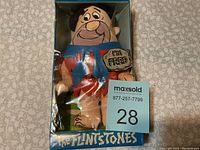 Fred Flintstone plush doll by Knickerbocker in original packaging, showing front view.
