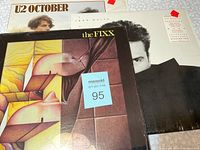Photo showing the covers of three vinyl music albums: U2 October, John Waite, and The Fixx.