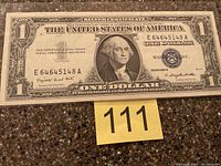 Front view of the 1957A one dollar silver certificate showing George Washington portrait and serial number E64645148A.