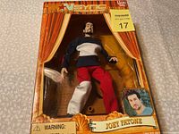 Front image of the Joey Fatone marionette in its original packaging showing the doll dressed in black, white, and red clothing with detailed realistic facial features.