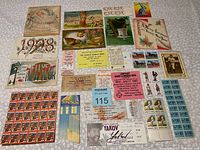 Wide view of the ticket stubs, post cards, stamps, and miscellaneous paper items spread out on a surface.