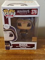 Front view of boxed Maria Funko Pop figure from Assassins Creed movie series, showing figure and box details.