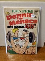 Full cover of the 1965 Dennis The Menace comic showing main characters and price.