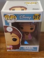 Front view of boxed Isabel Funko Pop vinyl figurine showing the character in pink dress and box with Pop logo, Disney logo, and number 317.
