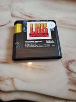 Front view of LHX Attack Chopper Sega Genesis game cartridge showing title label and yellow connector.