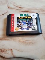 Front-facing photo showing label of NHL All-Star Hockey '95 Sega Genesis cartridge with condition and details visible.