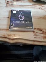 Front cover of Resident Evil 6 for PS3 showing game title, player rating, and Capcom branding.