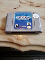 Front view of Nintendo 64 cartridge for NBA Showtime on NBC game, showing clear label and logos.