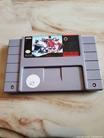 Front view of Stanley Cup Hockey SNES cartridge showing label artwork and cartridge shape.