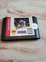 Front of Sega Genesis game cartridge showing World Series Baseball 95 label and artwork with condition sticker.