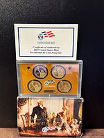 Front view of the 2007 US Mint Presidential $1 Coin Proof Set in clear plastic case with box and COA behind.