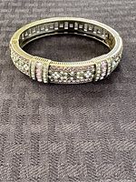 Front and top view of gold-tone Heidi Daus bracelet showing geometric rhinestone design and blush rhinestone accents.