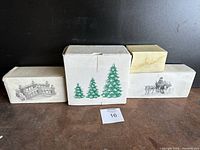 Four original boxes showing black and green printed images of the items inside: trees, bridge, horse carriage.