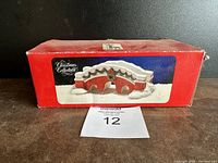 Red brick bridge figurine in original red box with 'Christmas Collectables' label.