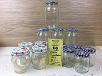 The full lot displayed with all jars and lids arranged on a wood surface, showing sizes and quantity.