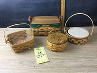 Lot of four Longaberger baskets including various sizes and types with liners and lids.