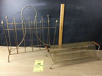 Photo showing both goldtone mid century metal magazine rack and record holder with measuring sticks to indicate size.