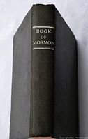 Closed view of black hardcover book spine showing 'Book of Mormon' in white text.