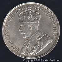 Obverse side of the 1936 Canada silver dollar coin depicting King George V with inscriptions.