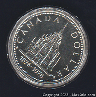 Close-up photo of the 1976 Canadian silver commemorative dollar coin showing detailed design of a Canadian building and date inscription.