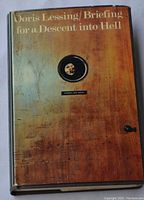 Front cover of the book showing the dust jacket with the image of a wooden door and round window.