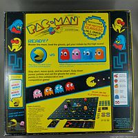 Box back showing game contents and instructions for Pac-Man The Board Game by Buffalo Games.