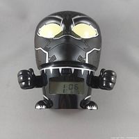 Front view of digital Black Panther character clock showing digital time display and stylized head with light-up eyes.
