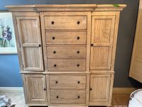 Full front view of the dresser showing four central drawers flanked by side cabinets and lower storage section