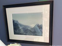 Frontal view of the framed watercolour painting by Linda Down, showing the misty mountainous landscape and the mat and frame surrounding it.