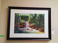 Full front view of framed watercolor painting mounted on wall