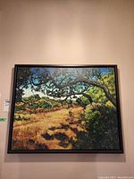 Full frontal view of framed painting hanging on wall.