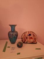 Overview of lot showing Robert Held vase at left, glass paperweight center front, and fish sculpture at right