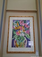 Full front view of framed watercolor floral painting with gold decorative frame and white double mat