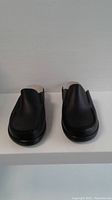 Front view of the black slip-on ladies shoes showing smooth toe area and stitching details.