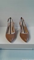 Front view of tan Franco Sarto slingback heels showing pointed toes and ankle straps.