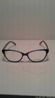 Front view of Fysh eyeglass frames showing black front rims and brand logo.
