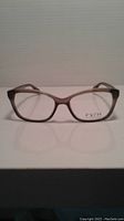 Front view of Fysh eyeglass frames on white background showing rectangular translucent brown plastic frame with clear lenses and visible Fysh branding.