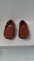 Front view of brown moccasin-style ladies shoes showing toe and stitching details.