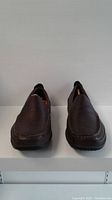 Front view of men's brown leather Hush Puppies loafers size 10XW
