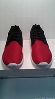 Front view of red and black men's size 11 shoes showing mesh upper and white sole