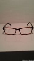 Front view of Perry Ellis rectangular eyeglass frames showing tortoiseshell brown rims and black temples