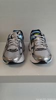Front view of pair of Saucony women's running shoes size 5, showing mainly silver and white mesh with white laces.