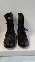 Front view of the black Steve Madden lace-up boots, showing toe and laces.
