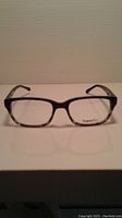 Front view of black and transparent rectangular eyeglass frames with no lenses.