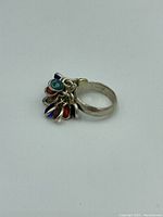 Photo showing side view of vintage cabochon dangle ring with multicolor cabochon pendants.