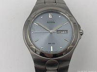 Front view of Citizen Eco-Drive watch displaying dial, hands, date and day function