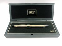 Cross 10Kt gold filled ballpoint pen in open case showing pen resting on black velvet interior.