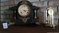 Both the antique mantle clock and the Kundo 400-day torsion clock side by side on a shelf