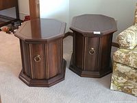 Pair of hexagonal wooden end tables side by side on carpet, showing overall shape and finish