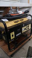 Overall view of generator with cable and adapter plug on wheeled platform